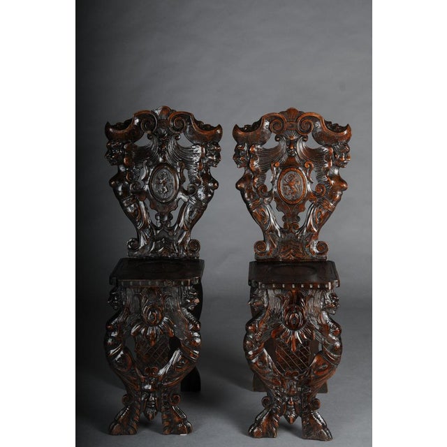 Pair of Antique Plank Chairs with Grotesque Decorations, Germany, 19th Century Two antique Italian chairs made of carved...