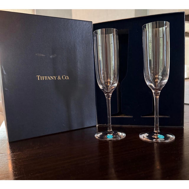 Vintage pair of Tiffany & Co. Champagne Flutes in original silk lined box, brand new, never used. Enjoy the simplicity of...