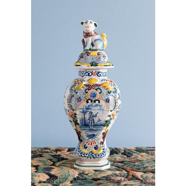This exquisite pair of 18th-century Dutch Delftware baluster vases is finely decorated with blue and white pastoral...