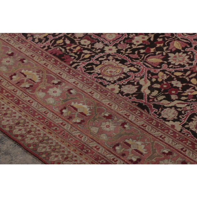 Hand-knotted in premium wool circa 1980-1989, this nearly 9x12 vintage Indian Agra rug emerges from the esteemed...