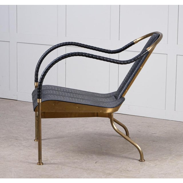 Brass frame. Seat and back in crocodile patterned prime leather. Leatherclothes-wound armrests. Limited edition of 360 pcs...