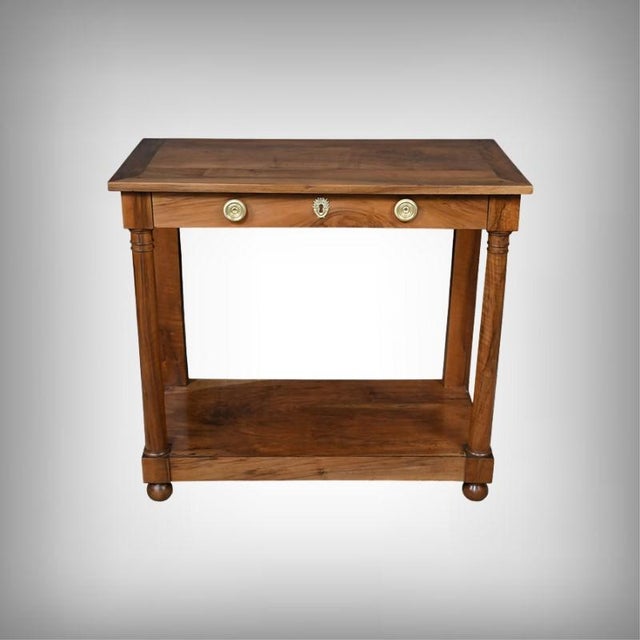 This walnut console table, crafted in the early 19th century in the purest Empire style, captivates with the nobility of...