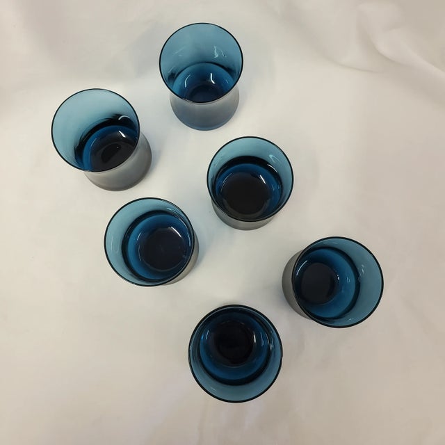 A set of 6 small Mid-Century glasses in a rich dark blue (not cobalt blue) and a curved shape. 2.25" x 2.25" and 3" tall....