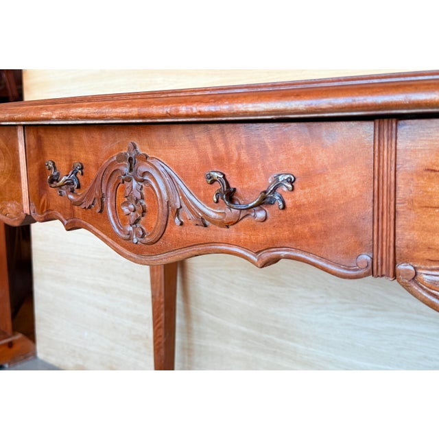 20th century Louis XV style French walnut writing desk with three drawers and cabriolet legs. Created in France during the...