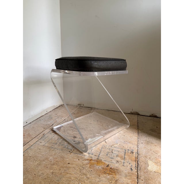 Vintage 1970s "Z" vanity stool with upholstered black cushion. The fabric has a slight leopard pattern to it. The lucite...