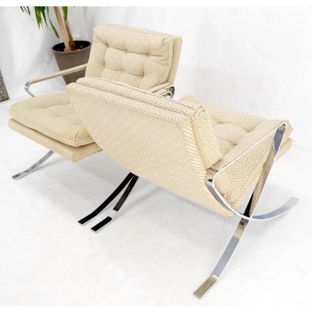 Pair of Mid-Century Modern polished stainless steel Bauhaus arm lounge chairs. Oatmeal tone texture upholstery fabric.