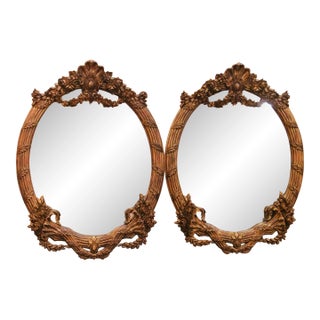 Pair of French Louis XV Style Carved Patinated Giltwood Oval Wall Mirrors For Sale