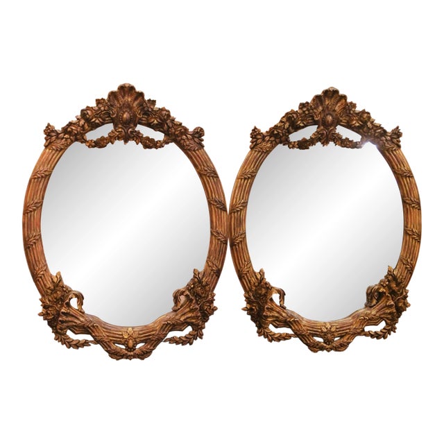 Pair of French Louis XV Style Carved Patinated Giltwood Oval Wall Mirrors For Sale