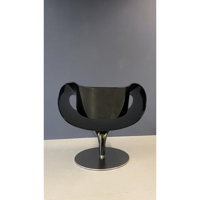Sleek and sophisticated, this black designer chair combines modern style with comfort. Its minimalist silhouette and...