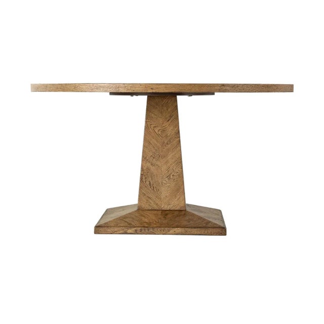 A rustic oak parquetry round dining table with column pyramid base. This elegant table is detailed with a herringbone oak...