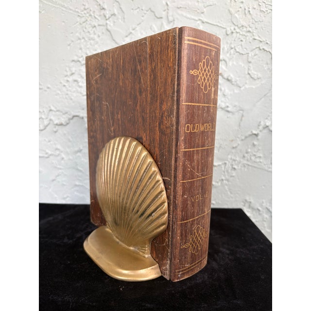 This elegant pair of vintage brass bookends features a sculptural scallop shell design with finely radiating ridges and a...