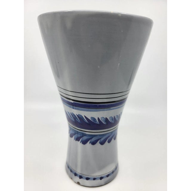 Roger Capron cornet vase in white glazed ceramic, blue and purple floral decoration. The design of this vase was created...