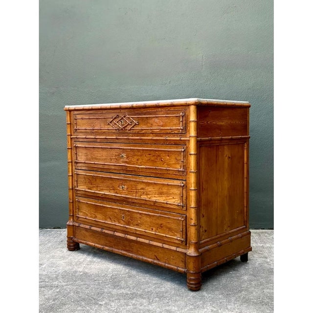 This vintage faux bamboo chest brings a distinctive mid-20th-century look to practical storage. Its wood frame is shaped...