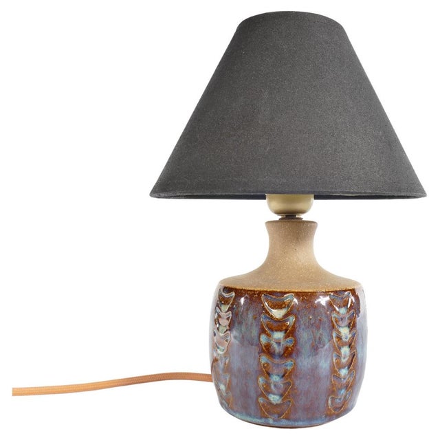 Handcrafted in the mid-20th century, this exquisite stoneware table lamp bear the distinctive mark of Søholm Stentøj....