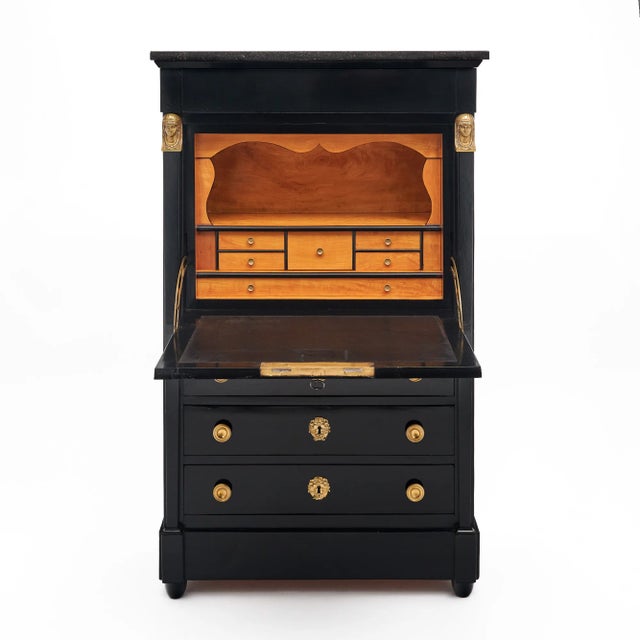Secretary from France in the Empire style. This piece is made of mahogany that has been ebonized and finished with a...