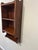 A charming Victorian-period walnut wall shelf, circa 1880s, featuring three graduated shelves, a scalloped crest rail with...