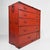 A Japanese chest of drawers in warm orange-red, with a timeworn finish and dark metal fittings. Weight: approx. 38kg...