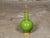 A luminous apple green porcelain vase, now configured as a single-socket table lamp, mounted on a circular giltwood base....