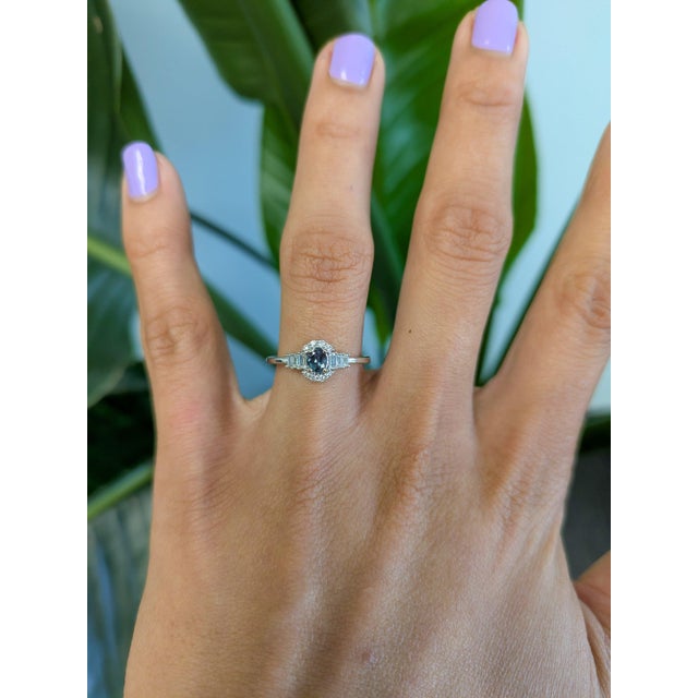 A natural colour-change alexandrite sits at the centre of this solid 14K white gold ring, framed by fourteen earth-mined...