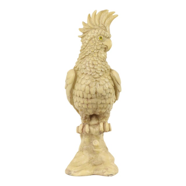 A heavy, solid vintage sculpture of a cockatoo on a tree trunk; a highly detailed piece crafted from alabaster composite...