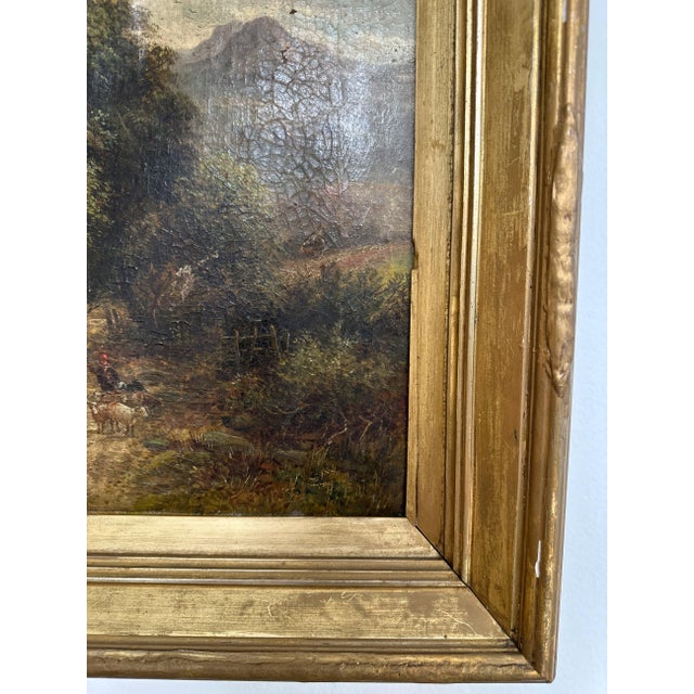A 19th-century English oil painting by W. Ellis, capturing a pastoral scene of a lone shepherd and his flock along a...
