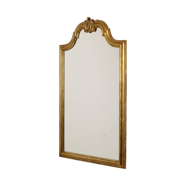 Beautiful vintage Deknudt mirror featuring a classic gold-tone resin frame adorned with an acanthus leaf crest; Hollywood...