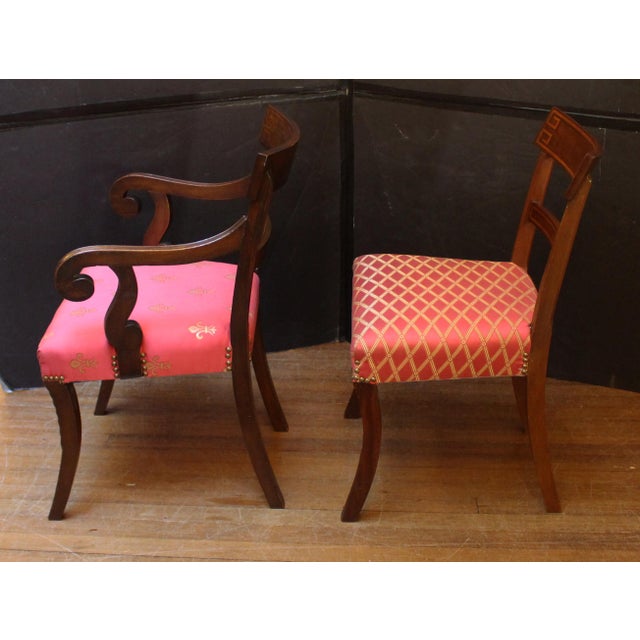 Circa 1830s Anglo-American Regency or Classical period set of eight dining chairs. Two arms and six sides. Raised on saber...