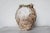 An hand made terracotta pot originally submerged under sea and used as a trap for an individual octopus. This pot has a...