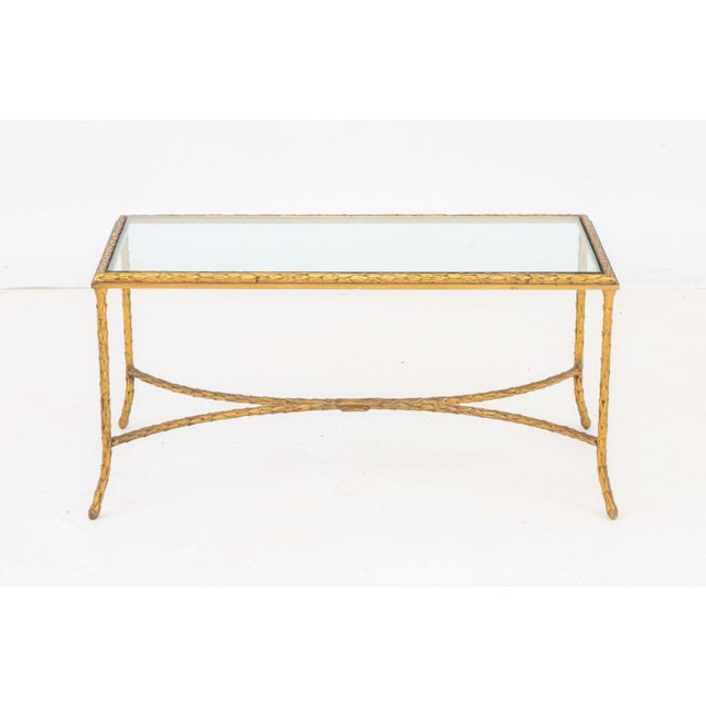 Maison Bagues Gilt Bronze Coffee Table, with glass top and laurel leaf motif. 17" H x 35" W x 20" D. Provenance: From an...