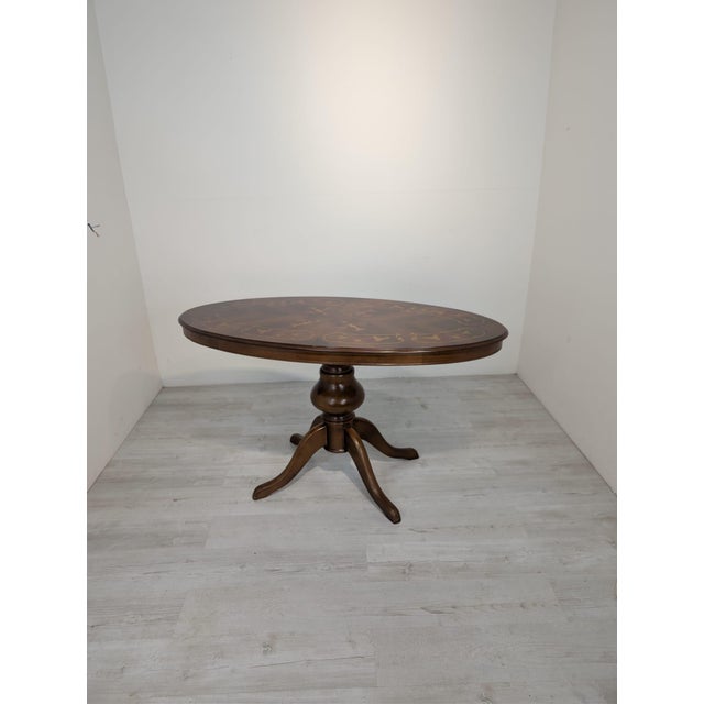 A unique, exceptionally elegant Italian-style oval table, captivating with its refined form, rich ornamentation, and...