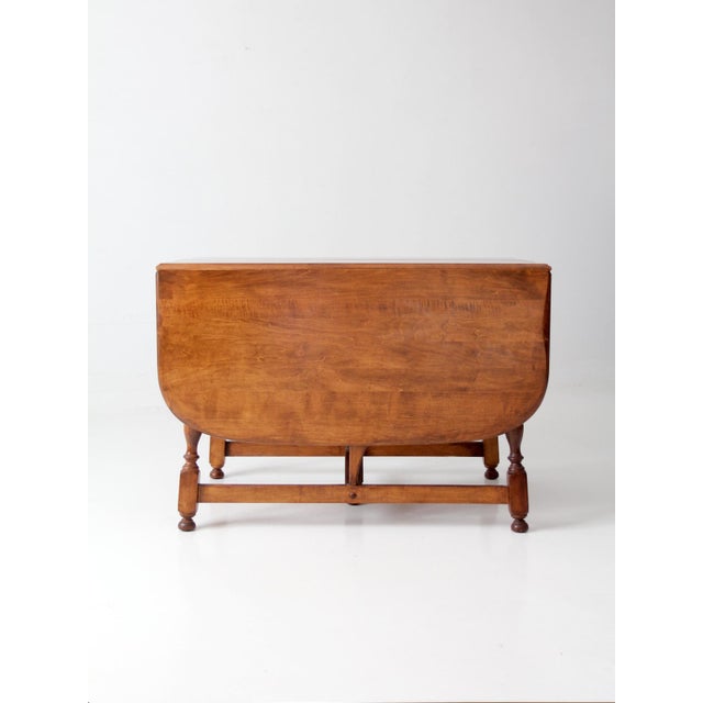 Elegant antique 1947 drop-leaf dining table by the American Chair Company of Sheboygan, Wisconsin. Featuring a softly...
