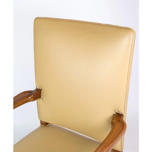 Armchair designed by Jacob Kjær in mahogany wood with bright new upholstered leather from around the 1950s. A chair with...