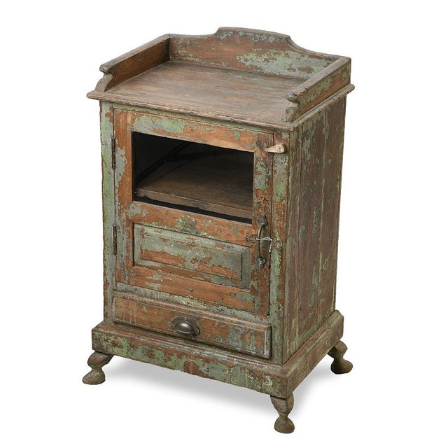 This twentieth-century bedside table boasts a delightfully patinated look, with layers of green paint that have peeled...