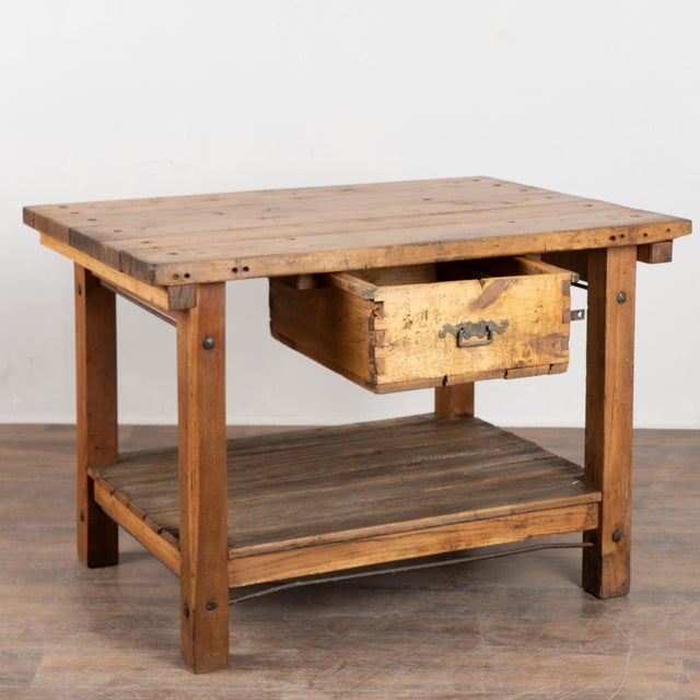 This early 20th-century Hungarian pine work table features a rustic, utilitarian design originally intended for everyday...