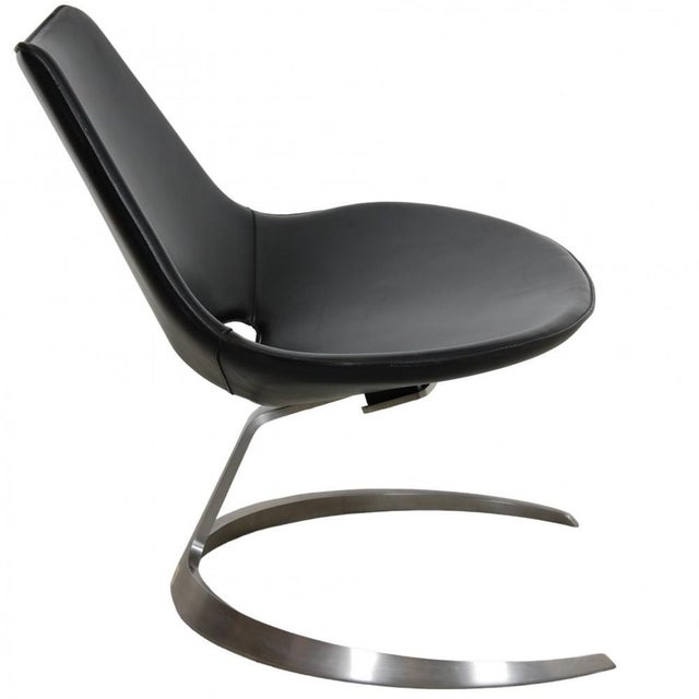 Fabricius and Kastholm Scimitar chair upholstered in black leather. The chair is from around the 1980s and appears in...