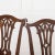An unusual pair of 18th Century Mahogany Side Chairs. The top rails with scroll ears and central carved splats of...