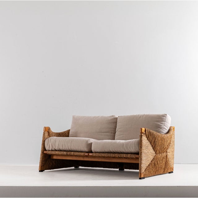 Rare Mario Bellini 'Papiro' Loveseat. Italy, c 1970 Wood, braided hemp rope, upholstery fabric. Good overall condition....