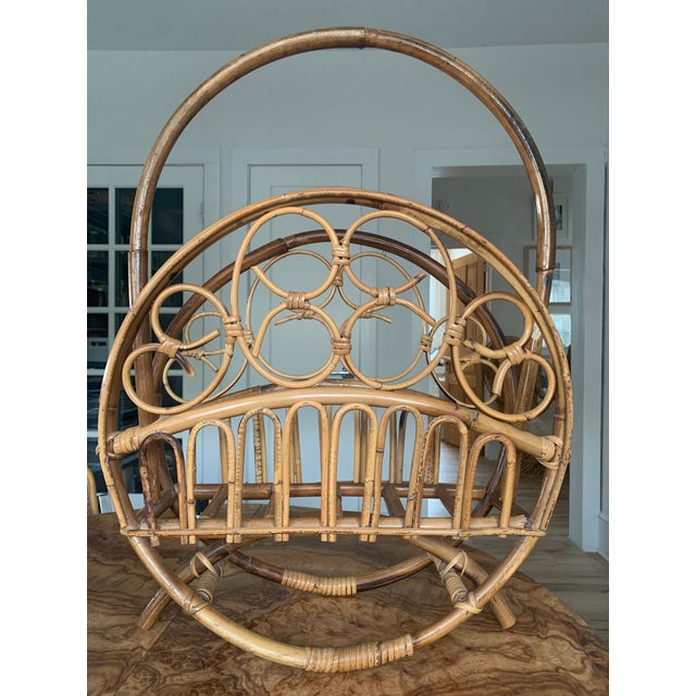 Elegant Italian magazine rack crafted from bamboo and woven rattan, dating to the 1950s. This charming mid-century piece...