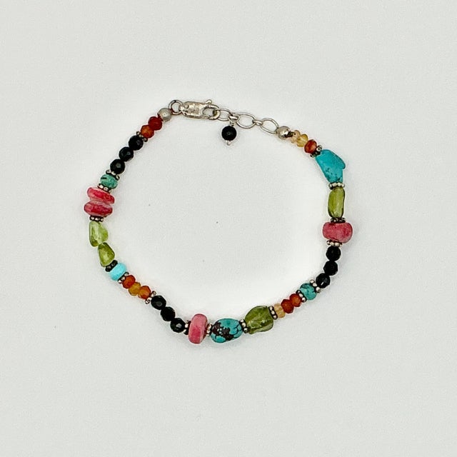 This is such a lovely little Beaded Bracelet. It has a colorful mix of beads and three petite Turquoise rocks. They are...