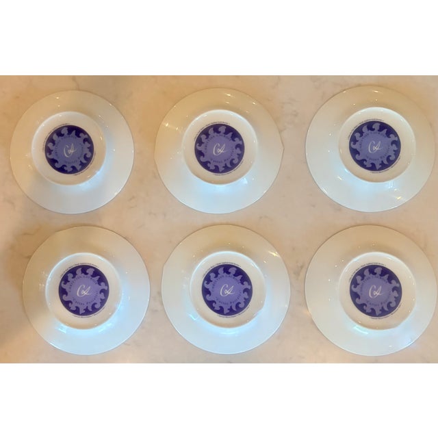 A rare and complete set of six porcelain salad plates designed by haute couture icon Christian Lacroix for his celebrated...