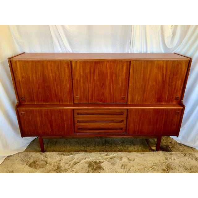 Handsome Danish teak sideboard/dry bar design by Johannes Anderson for J. slamming & Sons. See Danish sticker photo. The...