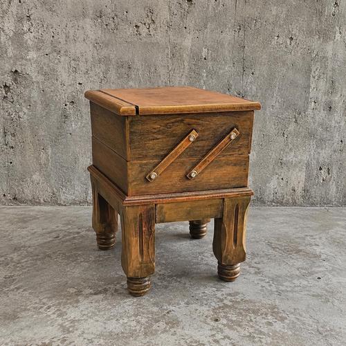 Wooden sewing table features an extendable scissor-action mechanism with multiple storage compartments and stands on...