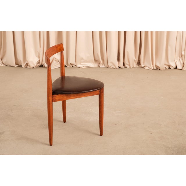 Two vintage Danish modern dining chairs in the Roundette manner, the three-legged triangular form that is one of the great...
