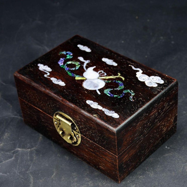 Beautiful Chinese hardwood jewelry keepsake box, decorated with exquisite mother-of-pearl shell inlay on the lid. The...