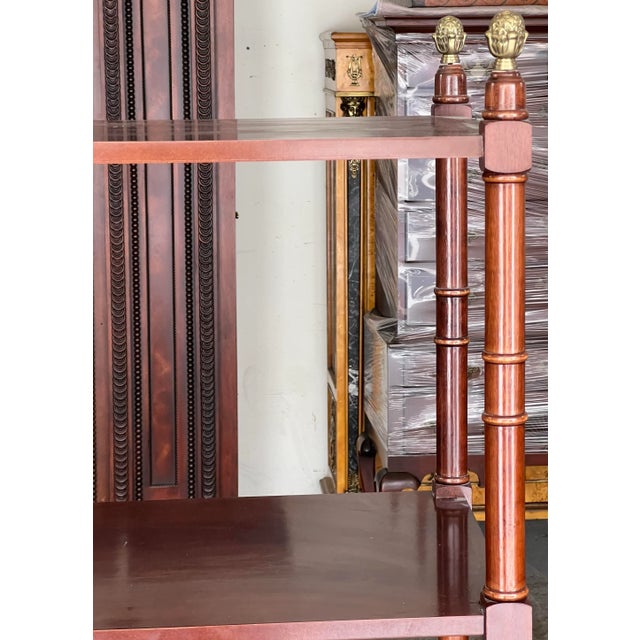 Beautiful chinoiserie faux bamboo shelving unit with brass pinecones onf the top bars. Beautiful mahogany color and...