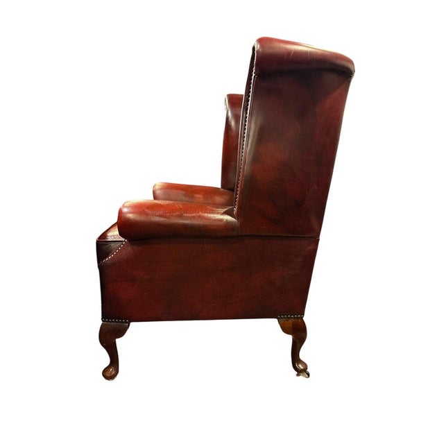 English Chesterfield Wingback Armchair England, mid-20th century Classic English wingback armchair upholstered in deep...