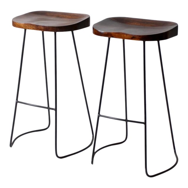 Pair of Vintage Sculpted Wood Saddle Seat Bar Stools With Black Iron Bases For Sale