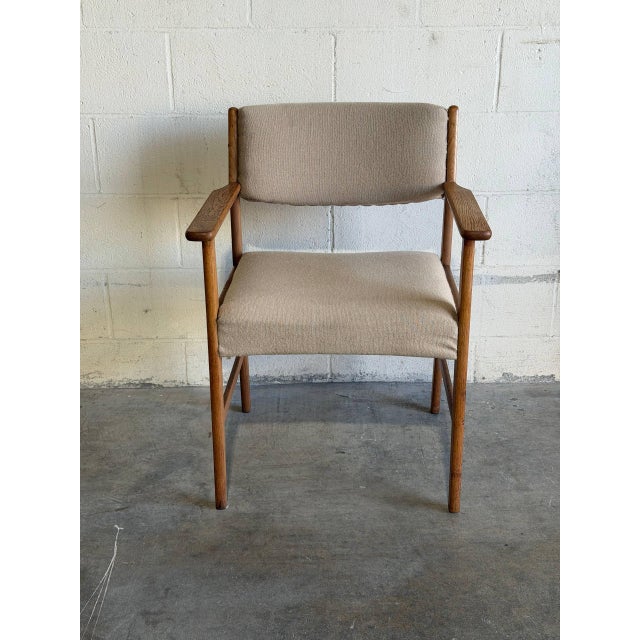 Crafted in Denmark, this elegant armchair features clean Scandinavian lines and a sturdy solid oak frame. The warm natural...