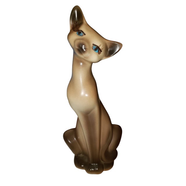 This striking vintage ceramic cat figurine is pure mid century glamour. Featuring an elongated Siamese-style silhouette,...