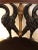 Dramatic carved wood armchair in mahogany, ebonized wood and gilded elements having elegant swan motif with arms that are...